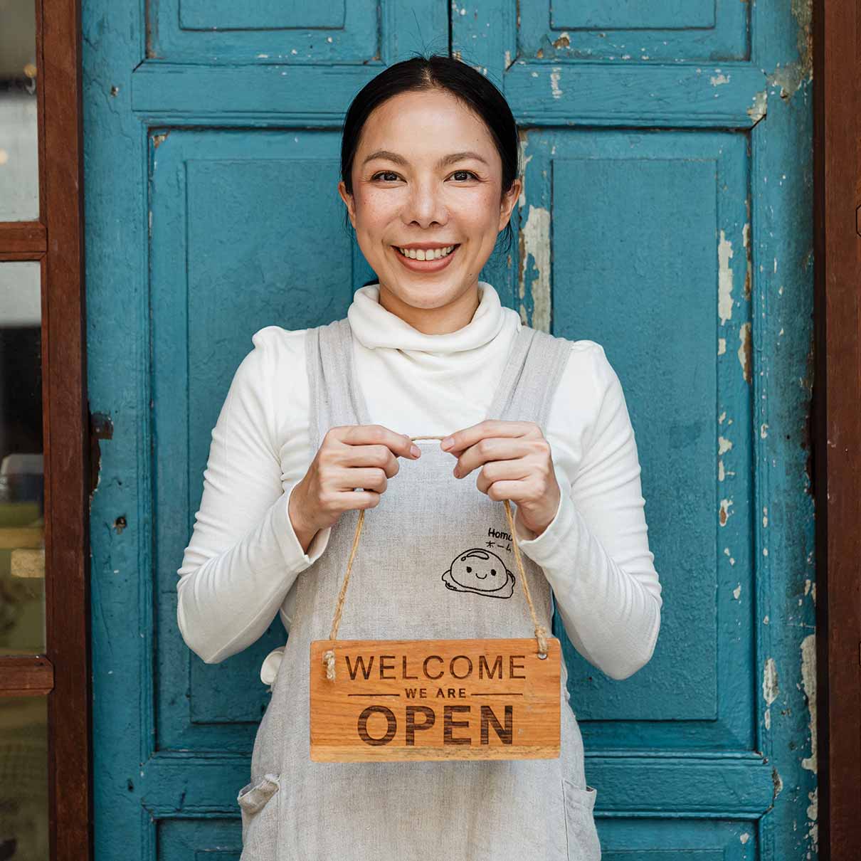 Woman Holding Welcome Sign